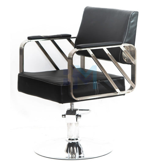Black barber chair with gold armrests